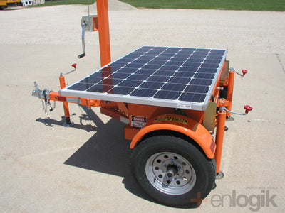 This closer picture provides a better view of the trailer, including solar panel, mast winch, outrigger jacks. The standard trailer color of safety orange is shown but custom colors are also available.